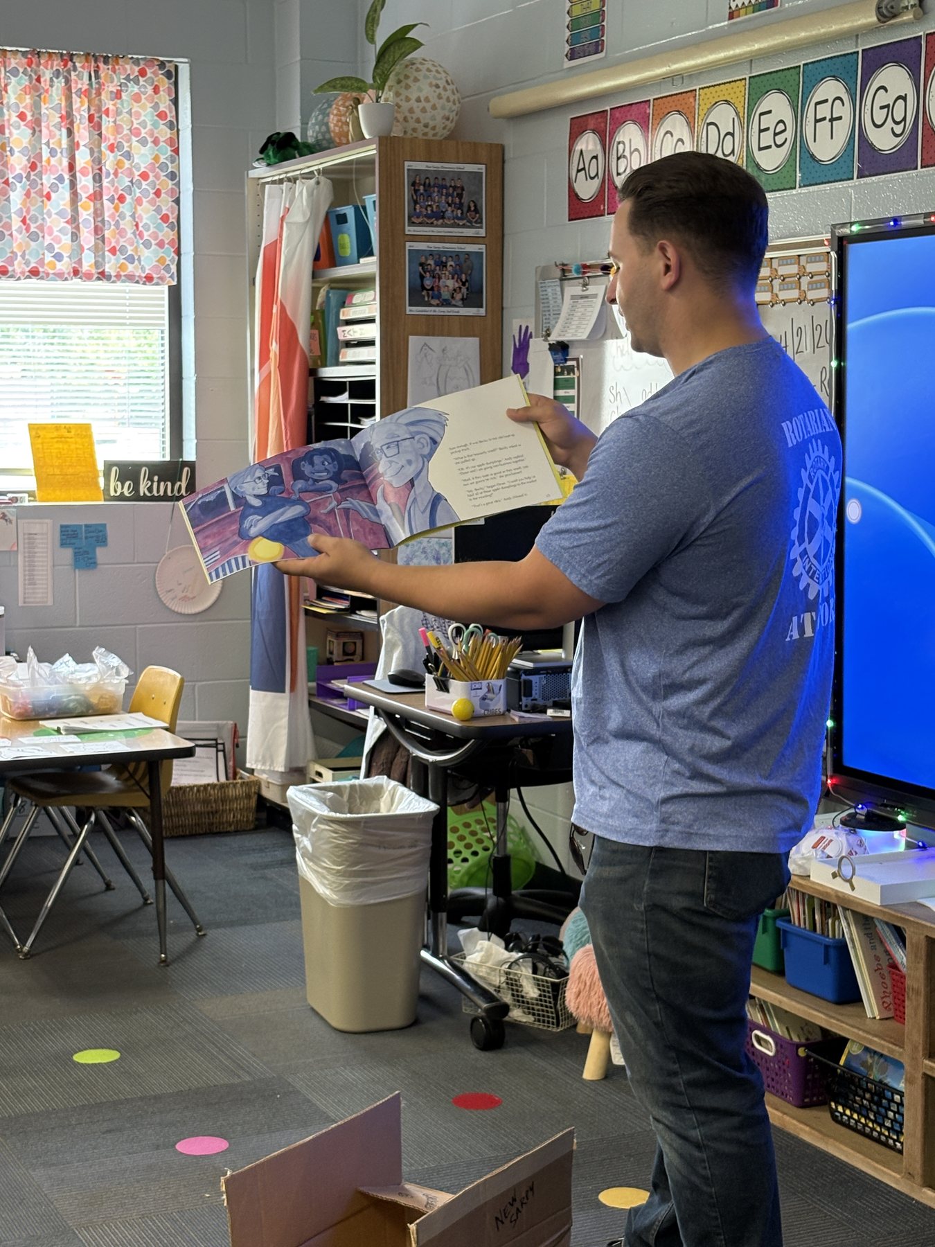 Joel Picolo reading during a school visit